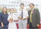  ??  ?? Koh (right) and Pang (left) posing with the two best debaters, Elton Tan Jun and Eunice Chan Ko Syn.