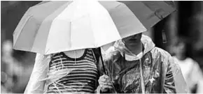  ??  ?? Twee mensen trotseren de kou en regen. (Foto: MSN)