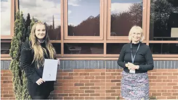  ??  ?? Amy with Head of English, Mrs Grehan-Bradley after winning the Oxford University poetry contest.