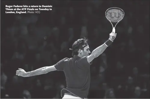  ?? Photo: VCG ?? Roger Federer hits a return to Dominic Thiem at the ATP Finals on Tuesday in London, England.