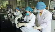  ?? PROVIDED TO CHINA DAILY ?? Top left: Students examine products in a laboratory at the luosifen industry school in Liuzhou, Guangxi Zhuang autonomous region.