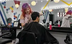  ?? Jerry Baker ?? Stylist Kelsey Holub, left, works on Ryan Guerrero’s hair at Birds Barbershop in The Heights.