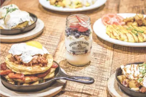  ?? PHOTOS BY PUCKETT’S GROCERY AND RESTAURANT ?? New breakfast items include the Southern Stack, left foreground, two sweet potato pancakes layered with pulled pork, fried apples, sunny-side-up egg on a bed of home fries; and Mason’s Jar, vanilla Greek yogurt layered with fresh seasonal fruit and...