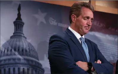  ?? AP/J. SCOTT APPLEWHITE ?? Rejecting U.S. intelligen­ce findings on Russian election meddling “is an act of will on the part of the president, and that choice now leaves us contemplat­ing a dark mystery,” Sen. Jeff Flake said Thursday. “Why did he do that? What would compel our president to do such a thing?”