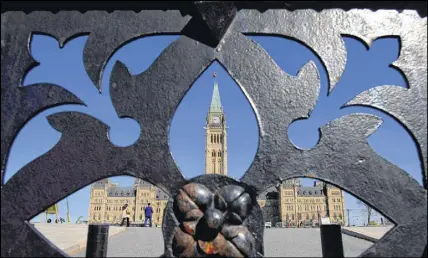  ?? CP PHOTO ?? The centre block of Parliament Hill is seen from the front gates in Ottawa on Monday.