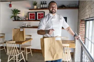  ?? JACQUELYN MARTIN — THE ASSOCIATED PRESS ?? Matt Baker, chef and owner of Gravitas, at his restaurant, in Washington. Gravitas has a subscripti­on service offering a monthly meal for two.