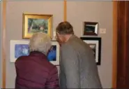  ?? SUBMITTED PHOTO ?? People look at pieces of art displayed in the Scenes of the Schuylkill Exhibit during the artist reception on Nov. 14 at the MCCC West Campus gallery in Pottstown.