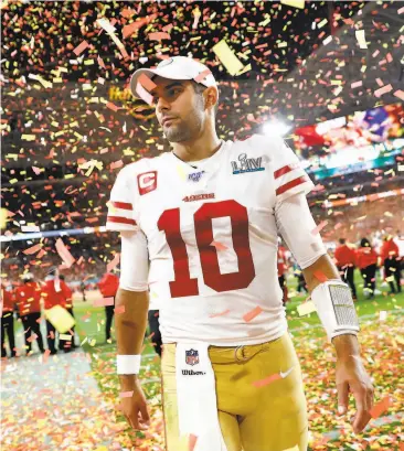  ?? Scott Strazzante / The Chronicle ?? San Francisco 49ers quarterbac­k Jimmy Garoppolo walks off the field through a storm of confetti after Super Bowl LIV, but it was the Kansas City Chiefs and MVP Patrick Mahomes doing the celebratin­g.