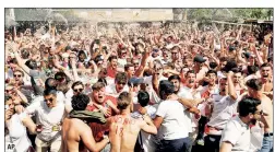  ??  ?? PARTY TIME: Fans at Flat Iron Square in London celebrate England’s first goal in Saturday’s 2-0 victory over Sweden in the World Cup quarterfin­als.