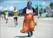  ?? JOSE LUIS GONZALEZ / REUTERS ?? An indigenous Tarahumara runner takes part in a half marathon along the streets in Guachochi, Mexico, on Sunday.