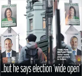  ??  ?? TIME FOR REFLECTION Voter walks past posters in Dublin