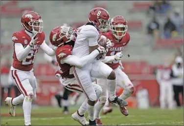  ?? Charlie Kaijo/NWA Democrat-Gazette ?? Making a tackle: Arkansas defensive back LaDarrius Bishop (24) tackles Alabama wide receiver John Metchie III (8), Saturday, December 12, 2020, during the third quarter of a football game at Donald W. Reynolds Razorback Stadium in Fayettevil­le.