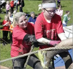  ??  ?? Louise Dunne and Amelia Rooney pull themselves up the last obstacle.