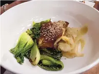  ?? HEATHER HUNTER/FOR THE JOURNAL ?? Grilled Miso Bass with Bok Choy and Pickled Ginger at Izanami.