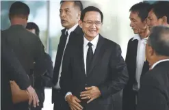  ??  ?? BANGKOK: Former prime minister Somchai Wongsawat, center, brother-in-law of Thaksin and Yingluck Shinawatra, arrives at the Supreme Court in Bangkok.—AFP