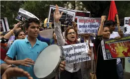  ?? — AP ?? Protesters shout slogans during a protest demanding release of all political prisoners in New Delhi on Wednesday. Five prominent rights activists were arrested for alleged Maoist links in a countrywid­e crackdown last week.