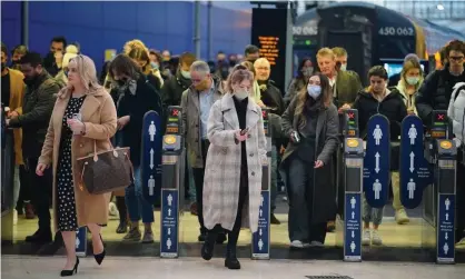  ?? Photograph: Dominic Lipinski/PA ?? Commuters at Waterloo station, London, after plan B measures were lifted in England, 27 January 2022.