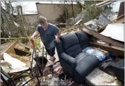  ?? GERALD HERBERT — THE ASSOCIATED PRESS FILE ?? Bradley Beard walks with a shovel through his daughter’s destroyed trailer home, after searching in vain for the water shutoff valve for the property in the aftermath of Hurricane Laura, in Hackberry, La., on Aug. 29.