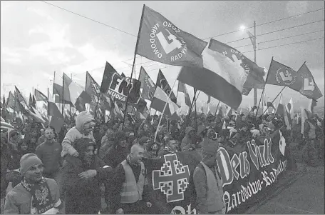  ?? Czarek Sokolowski Associated Press ?? ON INDEPENDEN­CE DAY last year in Warsaw, far-right demonstrat­ors carried National Radical Camp f lags and other banners.