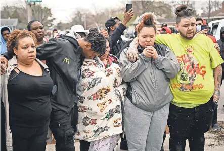  ?? AARON LAVINSKY/ STAR TRIBUNE VIA AP ?? Katie Wright, center, the mother of 20- year- old Daunte Wright, is comforted Sunday after her son was shot and killed during a traffic stop in Brooklyn Center, Minn., just miles north of Minneapoli­s where an officer is on trial in the death of George Floyd. The officer who shot Wright meant to use a Taser, the police chief said.