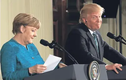  ?? Picture: Getty Images. ?? German Chancellor Angela Merkel and US President Donald Trump take questions from the media during yesterday’s press conference at the White House.