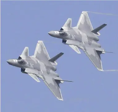  ?? Yomiuri Shimbun file photo ?? Chinese J-20 stealth fighter jets fly at the China Internatio­nal Aviation and Aerospace Exhibition in November 2018 in Zhuhai, Guangdong Province, China.