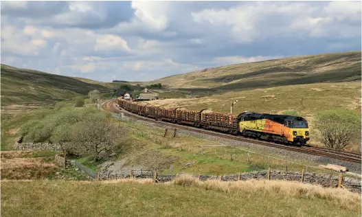  ??  ?? ABOVE: Colas Class 70 70817 passes Blea Moor on the Settle to Carlisle line on May 27 with the 6J37 logs working. (Chris Gee)