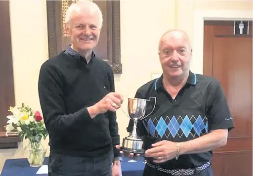  ??  ?? Ivor Williams, the Macc Seniors Organiser present the Seniors Spring Cup to Rod Price