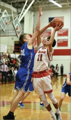  ?? PAUL DICICCO — FOR THE NEWS-HERALD ?? Mentor’s Alex Edwards goes up for a shot against a Brunswick defender on Feb. 8.