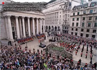  ?? ?? ■ Members of the public and participan­ts gather for the second Proclamati­on in the City of London at the Royal Exchange