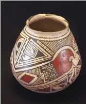  ?? ?? Made in the Casas Grandes region of Mexico around 1300 A.D., this vessel features a macaw head at the end of a serpent’s tail.