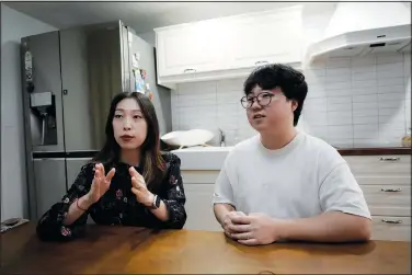  ?? (AP/Ahn Young-joon) ?? Yoo Young Yi speaks as her husband, Jo Jun Hwi, listens Oct. 2 during an interview at their home in Seoul. The couple has decided to not have children, part of a growing trend in South Korea.
