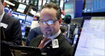  ?? PHOTO/RICHARD DREW ?? Trader Robert Arciero works on the floor of the New York Stock Exchange on Friday. AP