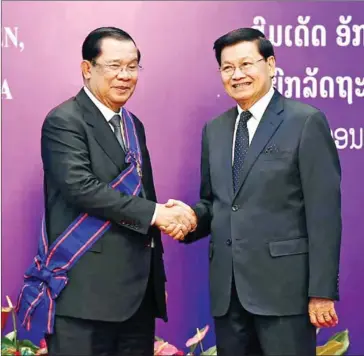  ?? SPM ?? Prime Minister Hun Sen shakes hands with Lao President Thongloun Sisoulith in the Lao capital Vientiane during the former’s visit in February.