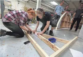  ?? JOHN KLEIN / FOR THE MILWAUKEE JOURNAL SENTINEL ?? Shorewood High School student Aliyah Goldberger works on sets with UWM student Ben Lisowski. After a fire, Shorewood offered its scene shop for UWM students to rebuild a set.