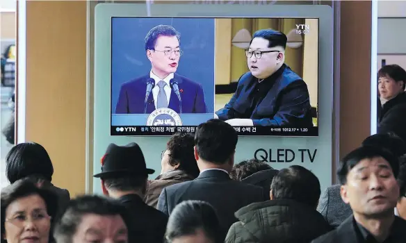  ?? — THE ASSOCIATED PRESS FILES ?? People watch a TV screen showing North Korean leader Kim Jong Un and South Korean President Moon Jae-in, left, at the Seoul Railway Station. The rival Koreas agreed on March 24 to hold high-level talks to prepare for an April summit.