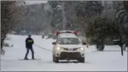  ?? MIC SMITH — THE ASSOCIATED PRESS ?? Sid Rismani skis behind a car while heavy snow comes down on the Isle of Palms, S.C., Wednesday.