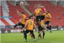  ??  ?? John Egan rises highest to beat Wolves’ Willy Boly to the ball in stoppage time. Photograph: Tom Jenkins/NMC Pool/the Guardian