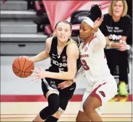  ?? Michael Woods / Associated Press ?? UConn guard Paige Bueckers (5) drives past Arkansas defender Makayla Daniels on Thursday.