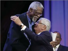  ?? FGIL — STEVEN SENNE ?? Former Boston Celtics basketball player Bill Russell, left, hugs National Basketball Associatio­n Commission­er David Stern during an award ceremony for the W.E.B. Du Bois Medal at Harvard University in Cambridge, Mass., on Oct. 2, 2013. Stern, who spent 30 years as the NBA’s longest-serving commission­er and oversaw its growth into a global power, died on Wednesday. He was 77.