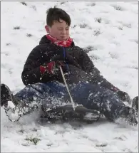  ??  ?? Óisín Donelon sledding at the upper dam at the reservoir.