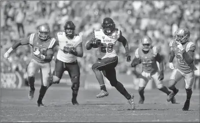  ??  ?? On the run: Utah running back Joe Williams, center, runs for a touchdown as UCLA defensive lineman Takkarist McKinley, left, linebacker Jayon Brown, second from left, and defensive back Jaleel Wadood, right, give chase along with Utah offensive tackle...