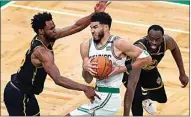  ?? ?? Boston Celtics forward Jayson Tatum (0) drives against Golden State Warriors forward Andrew Wiggins, left, and forward Draymond Green (23) Friday in Boston.