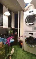  ??  ?? (Left) The loud colours of the kitchen cabinets complement the lime-green Smeg fridge. (Right) Fake lawn grass and potted plants decorate the balcony where the washing machine and dryer are.