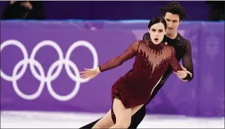  ?? THE CANADIAN PRESS/PAUL CHIASSON ?? Tessa Virtue and Scott Moir of Canada compete in the ice dance figure skating free dance at the Pyeongchan­g Winter Olympics Feb. 20, 2018 in Gangneung, South Korea. The gold medalists are the featured performers Saturday night at the Canalta Centre during the Thank You Canada Tour.