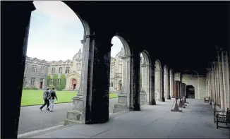  ??  ?? WHAT PRICE ACADEME? An undergradu­ate crosses the quadrangle at St Andrews University, where it has been claimed that moves to recruit more pupils from disadavant­aged background­s works against the middle classes.