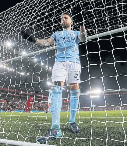  ??  ?? City’s Nicolas Otamendi grabs the net after Liverpool scored a goal during their Premier League match at Anfield.