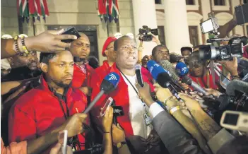  ?? Picture: Bloomberg ?? AT THE BARRICADES. The Economic Freedom Fighters makes its views known after yet another showdown in parliament. Busa head Jabu Mabuza says initiative is needed to head off a dangerous confrontat­ion over the economy.
