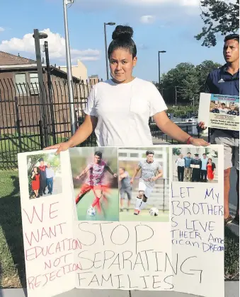  ?? RACHEL CHASON/ WASHINGTON POST ?? Fatima Claros Saravia cries as she stands with a sign she made for her brothers, Diego and Lizandro Claros Saravia, who have been arrested and are under threat of deportatio­n.