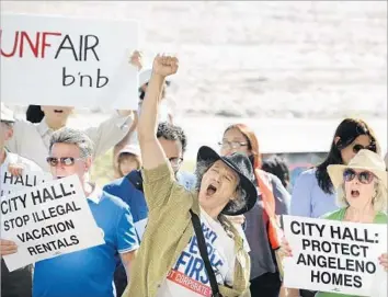  ?? Christina House For The Times ?? RESIDENTS AND affordable-housing activists rally on the Venice boardwalk in 2015. A deal struck with Airbnb has brought in more than $20 million in lodging taxes to Los Angeles this fiscal year.